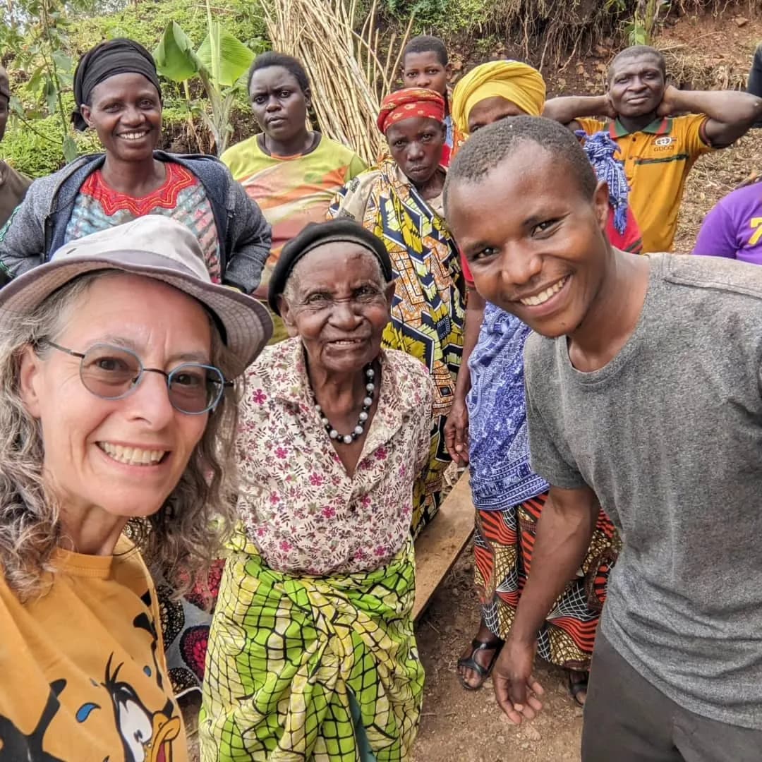 A traveler with a local guide hiking the Congo Nile Trail in Rwanda while engaging with the community — one of the highlights featured in the 10 Best Hiking Tours and Trails in Rwanda.