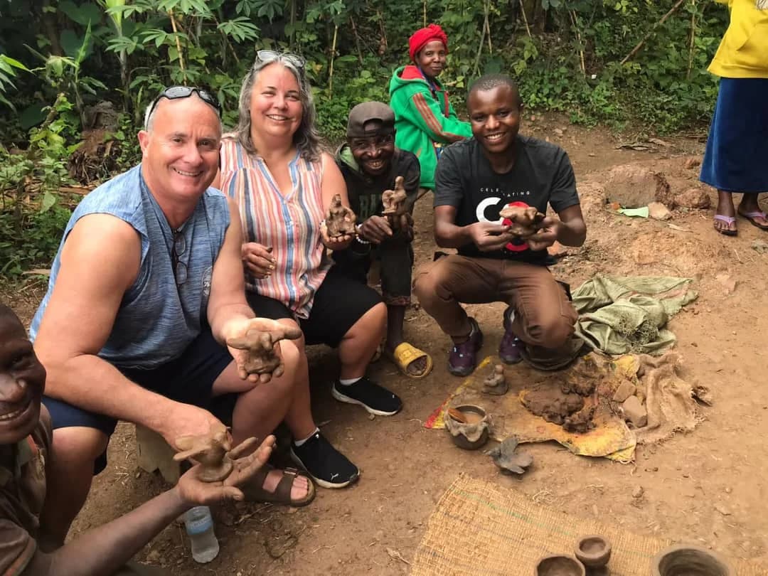 Travelers enjoying a cultural poetry experience along Rwanda’s scenic Congo Nile Trail, connecting with local storytellers and nature.