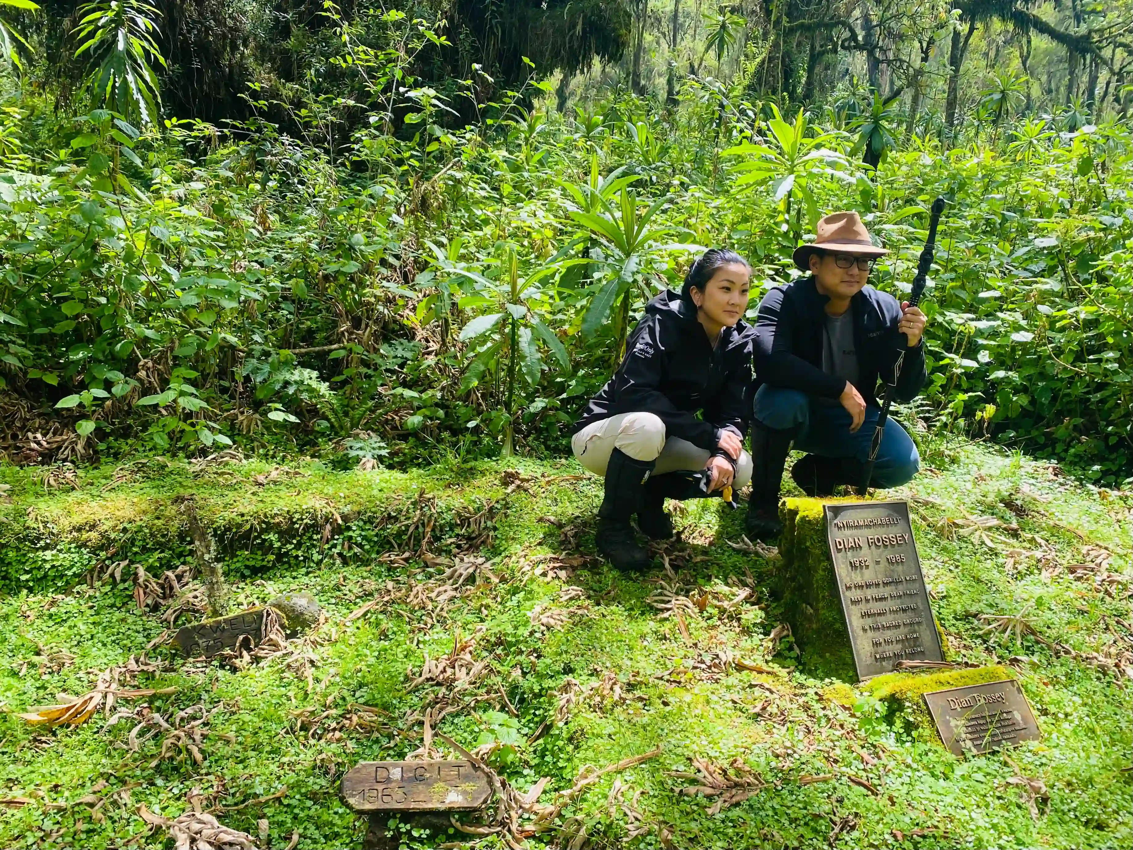 Couple visiting Dian Fossey’s grave in Volcanoes National Park, Rwanda, capturing a meaningful moment together