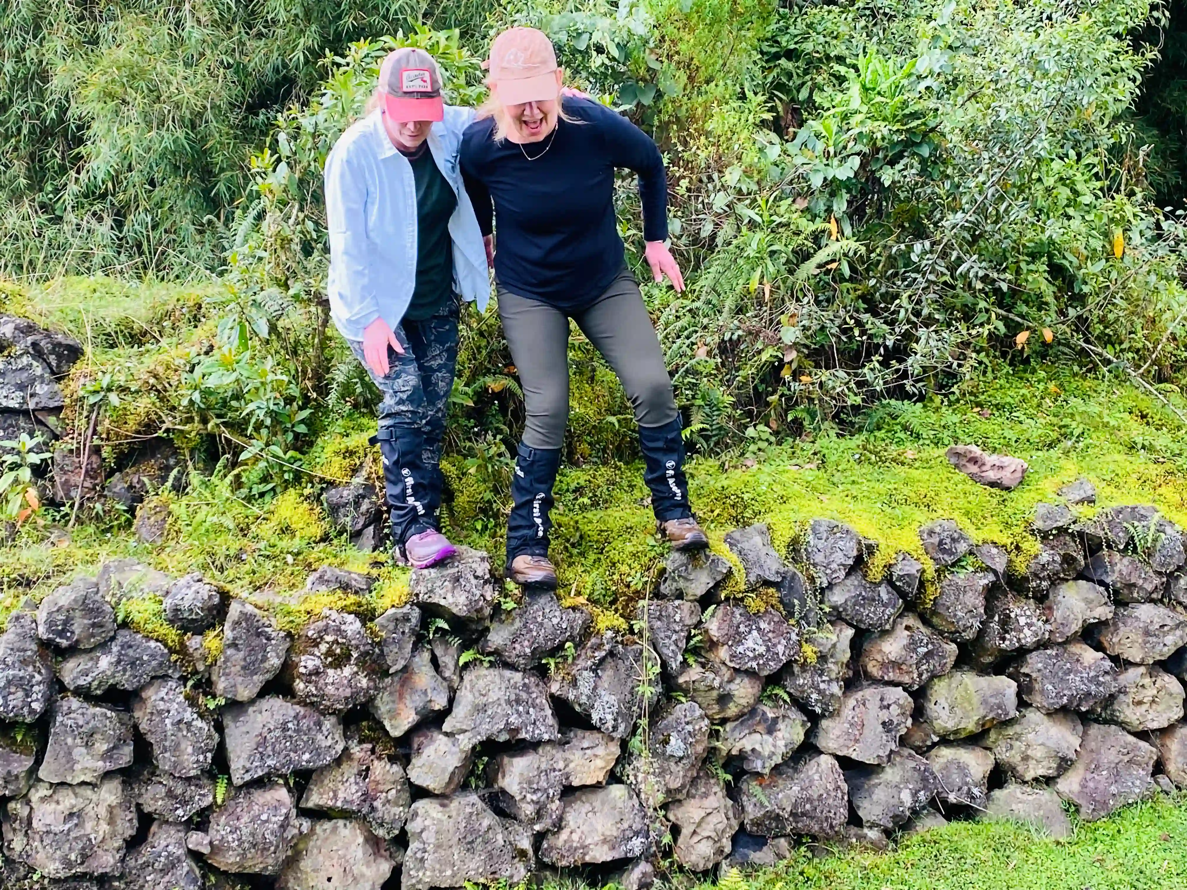 Two women leaving Volcanoes National Park dressed appropriately for gorilla trekking – essential guide for what to pack for gorilla trekking: updated essential list.