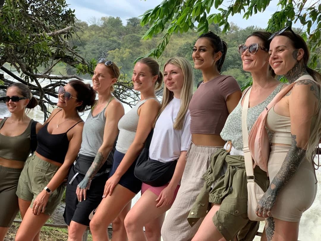 Group of women travelers enjoying the breathtaking Murchison Falls in Uganda, adventure and nature experience