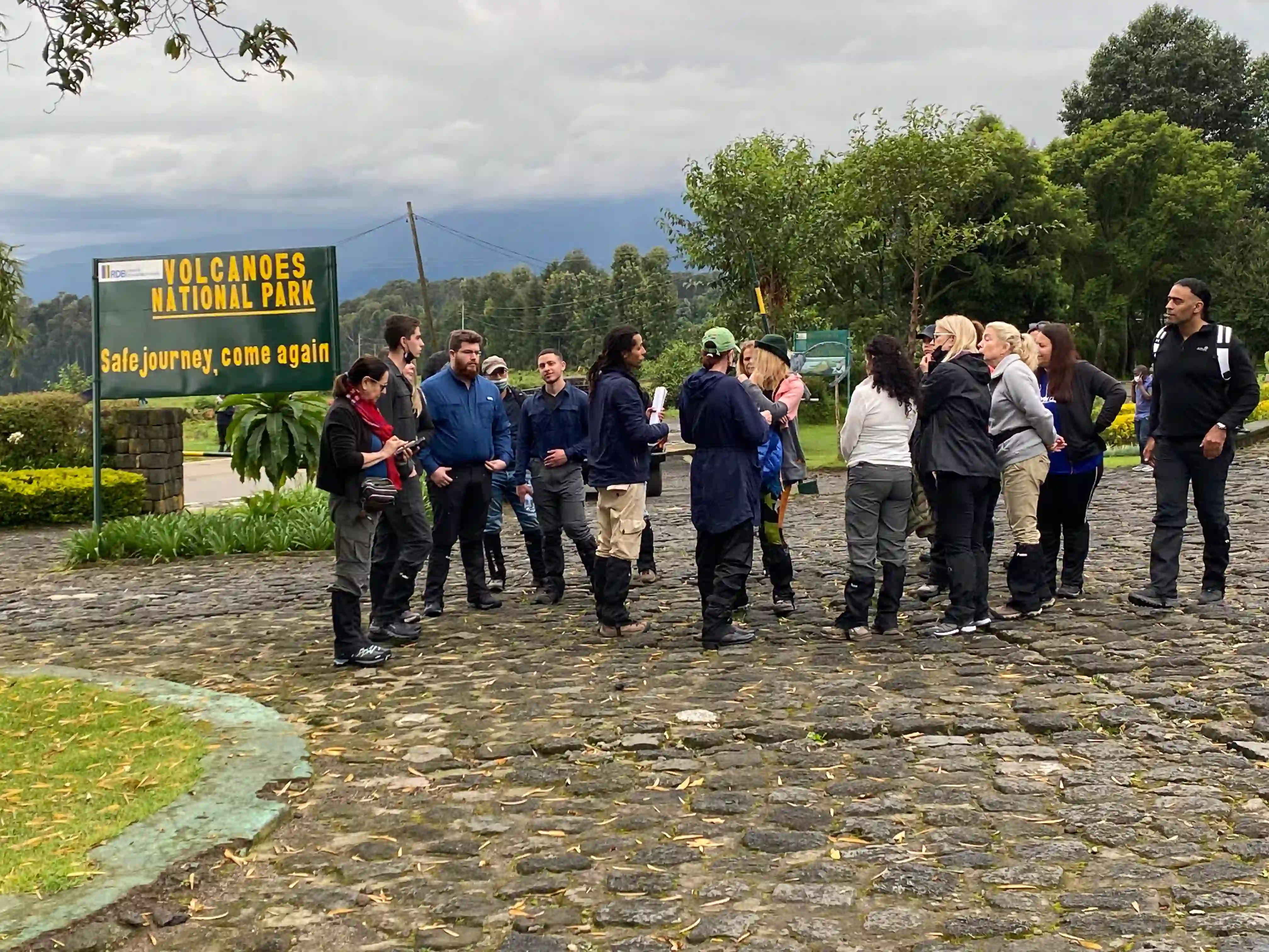 Group Mountain Gorilla Trekking in Rwanda: The Ultimate Safari Experience — travelers receiving a pre-trek briefing before entering Volcanoes National Park for a guided gorilla safari.