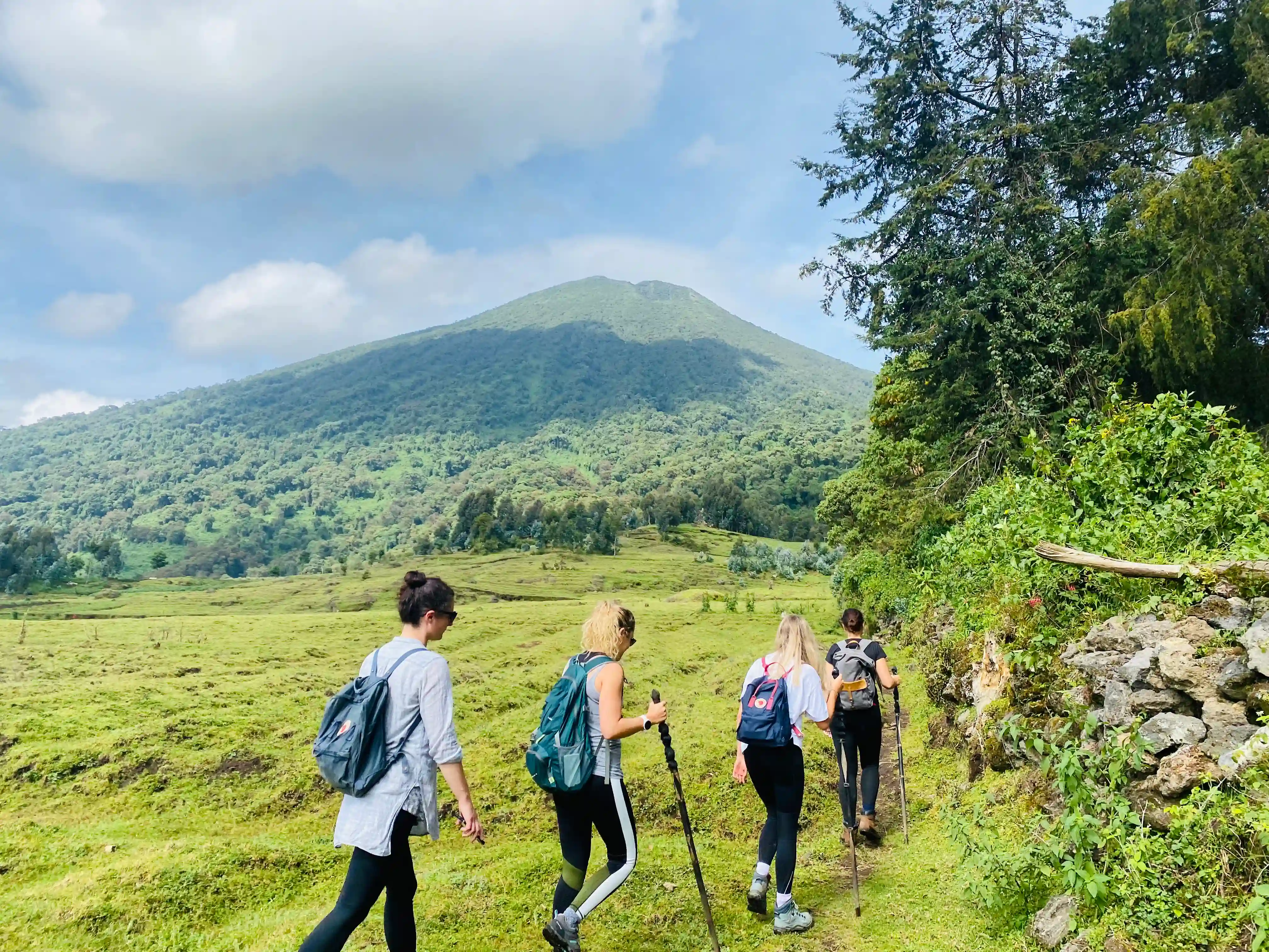 Traveler hiking Mount Gahinga on one of the 10 best hiking tours and trails in Rwanda, surrounded by volcanic landscapes and lush highland scenery