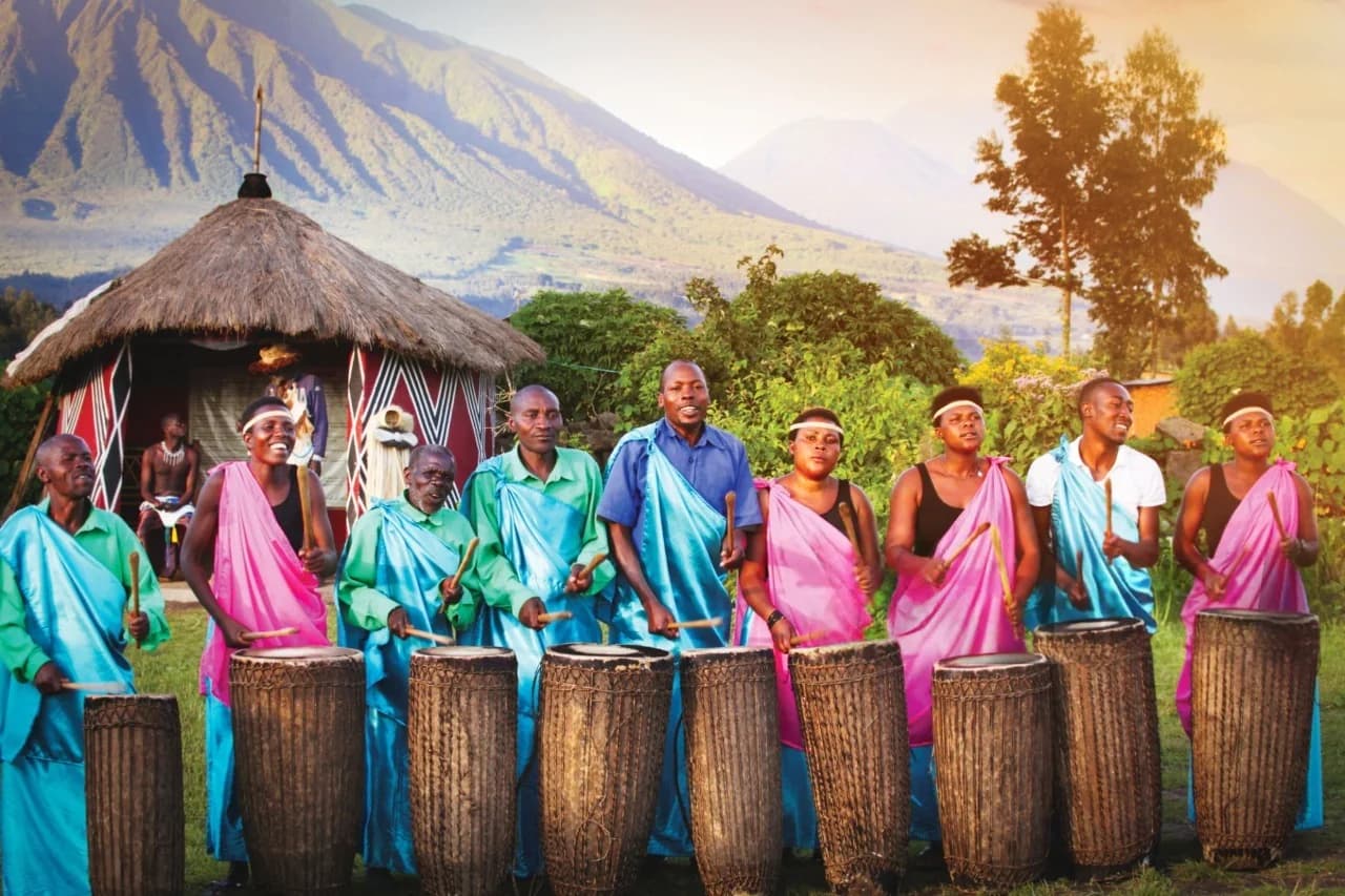 Local performers drumming in front of a traditional king’s house at Iby’Iwacu, showcasing vibrant Rwanda culture and heritage.