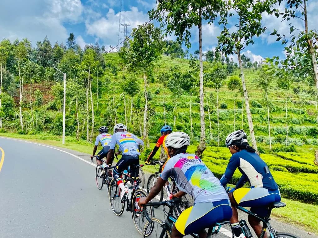 Cyclist riding from Kigali to Musanze near the Volcanoes National Park on a scenic mountain highway — road cycling tours in Rwanda.