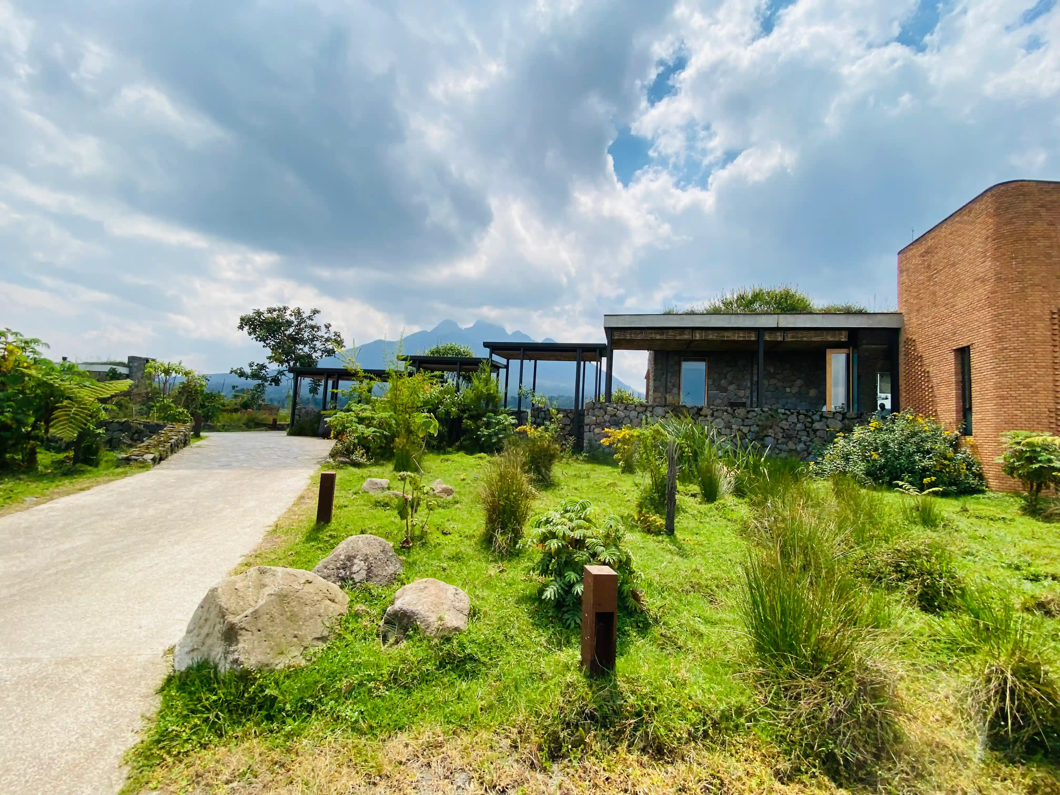 Exterior view of One&Only luxury hotel surrounded by lush tropical gardens and elegant architecture in Rwanda.