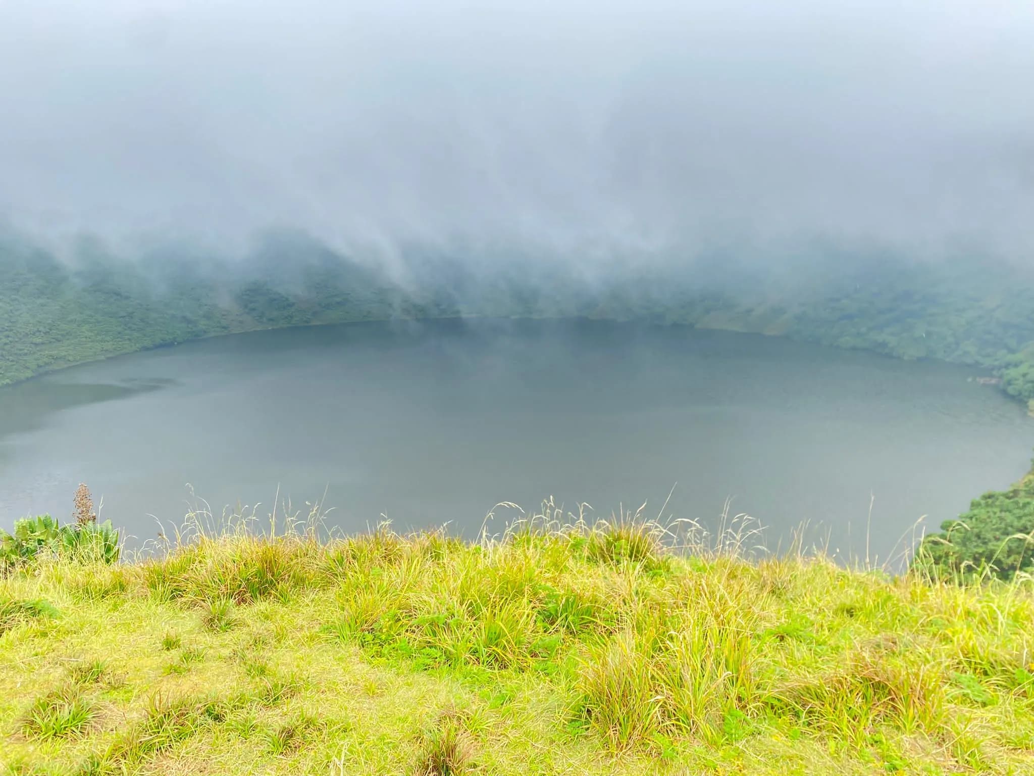 Mount Bisoke crater lake on a scenic volcanic hiking trail in Rwanda, showcasing stunning views for the 10 Best hiking tours and trails in Rwanda.