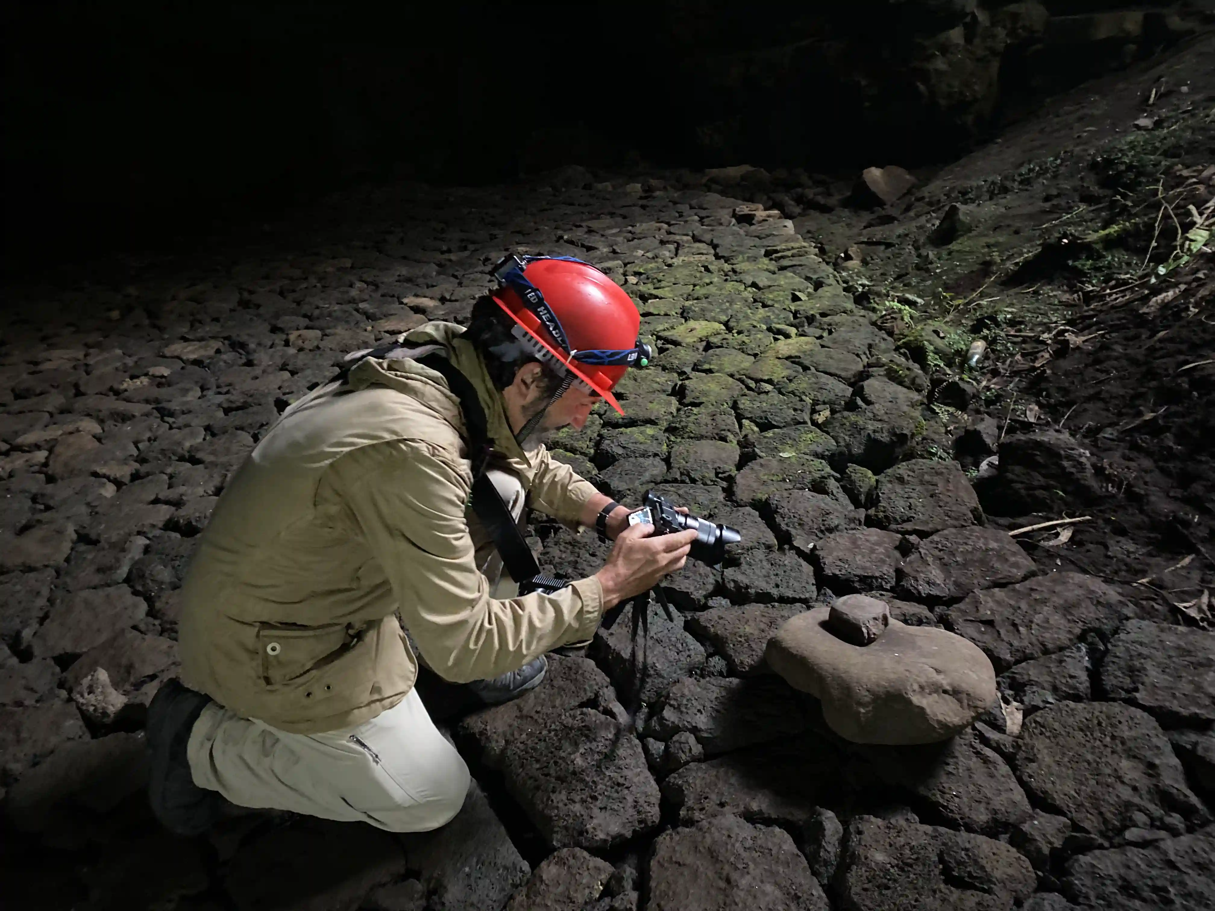 Traveler exploring Musanze Caves in Rwanda takes photos of Urusyo, a traditional Rwandan grinding stone used for making flour — showcasing Rwanda’s rich cultural heritage.
