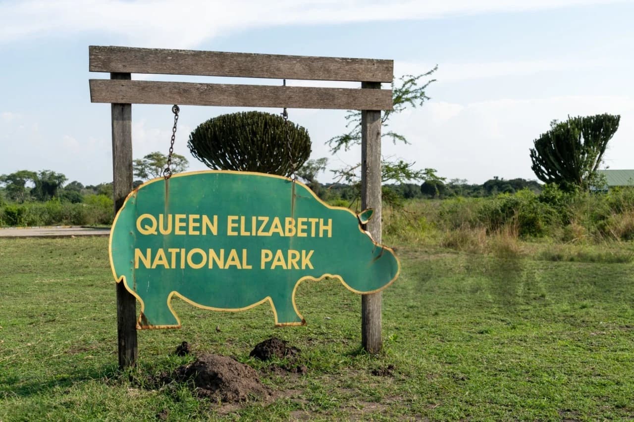 Gates of Queen Elizabeth National Park in Uganda, symbolizing the start of an iconic safari experience while comparing Queen Elizabeth vs Murchison Falls safaris for wildlife, landscapes, and adventure.