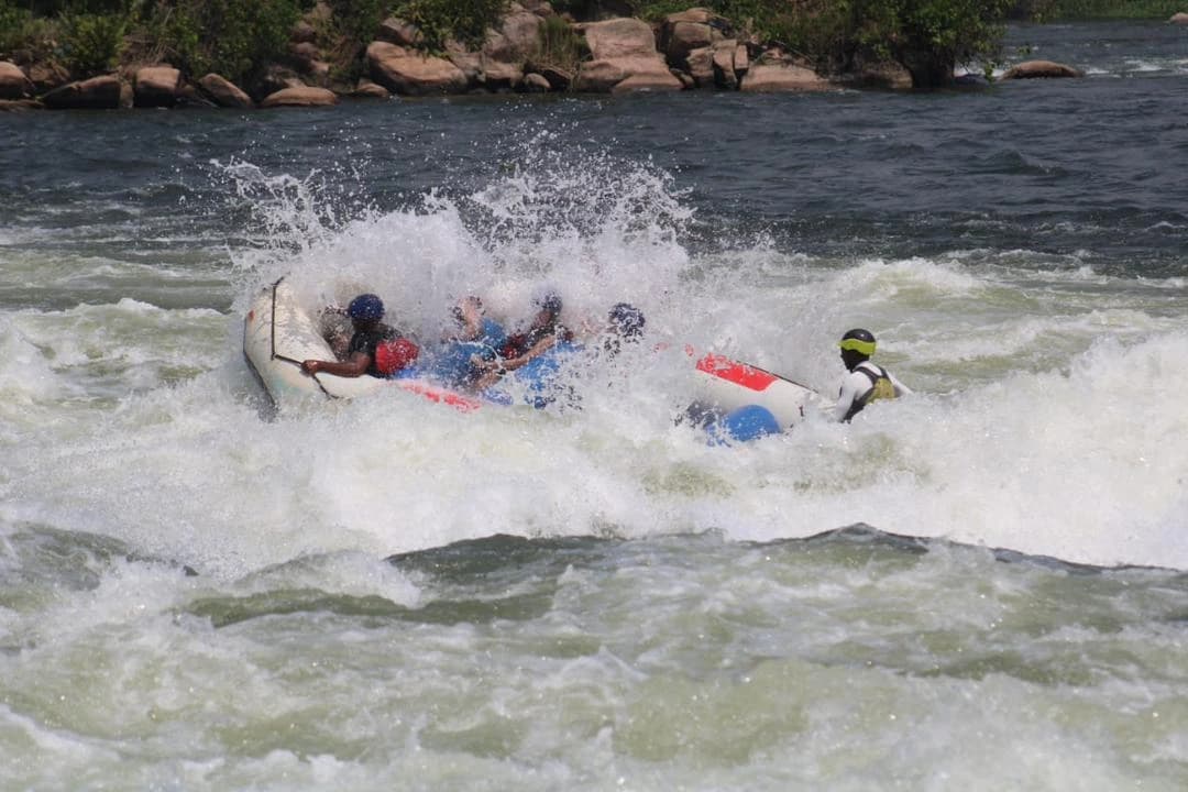 Travelers white-water rafting on the Nile River in Jinja, Uganda, adventure tourism experience in East Africa.