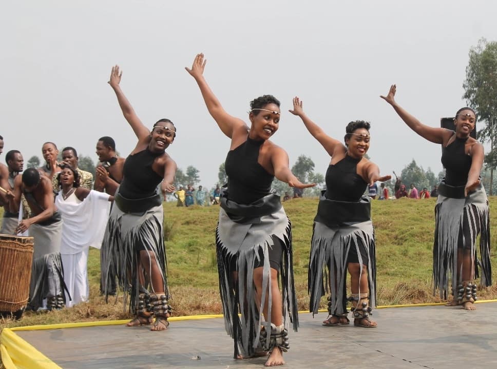 Rwandan girls performing traditional cultural dances near Volcanoes National Park, showcasing Rwanda’s vibrant heritage during a mountain gorilla trekking experience in Rwanda