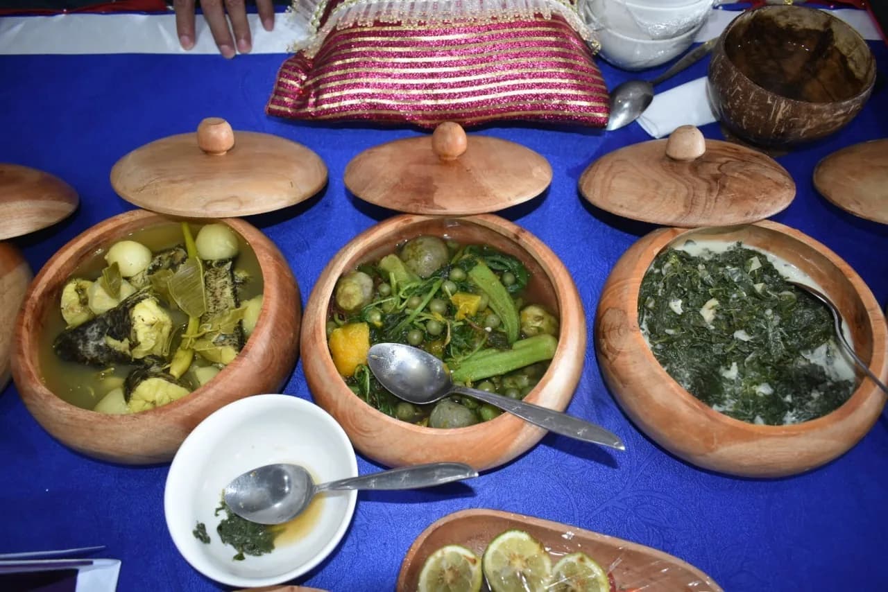 A vibrant display of traditional Rwandan dishes arranged on a table, showcasing the rich flavors and communal spirit of Rwanda culture.