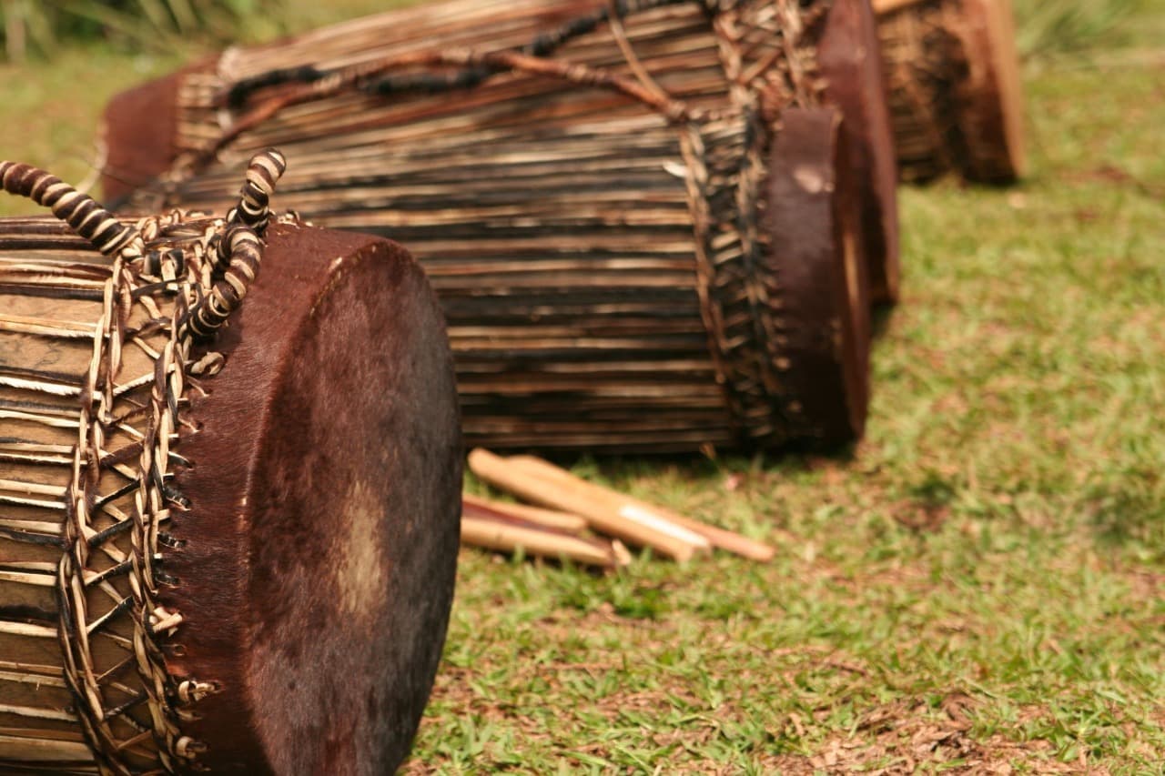 Traditional Rwandan drums arranged on the ground, showcasing the rich rhythms and heritage of Rwanda culture.