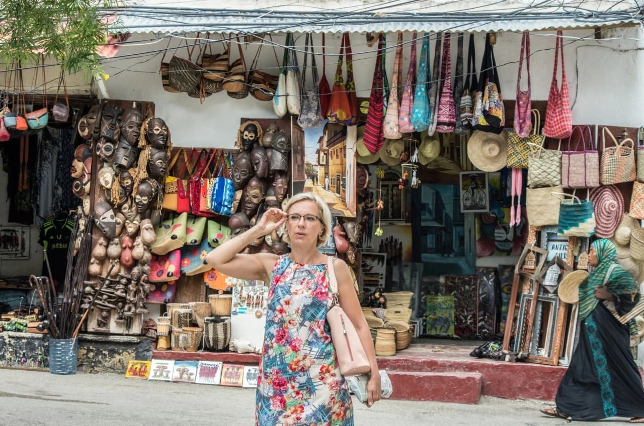 Traveler browsing colorful handmade souvenirs in Zanzibar market – How To Visit & Experience Zanzibar: Ultimate Travel Guide.