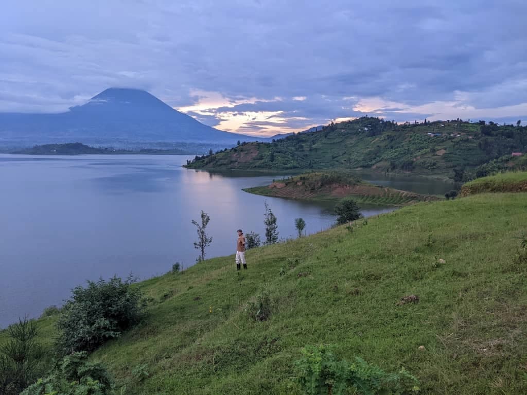 Traveler overlooking Rwanda’s Twin Lakes at sunrise, embracing local experiences and culture — How To Experience Rwanda Like a Local.