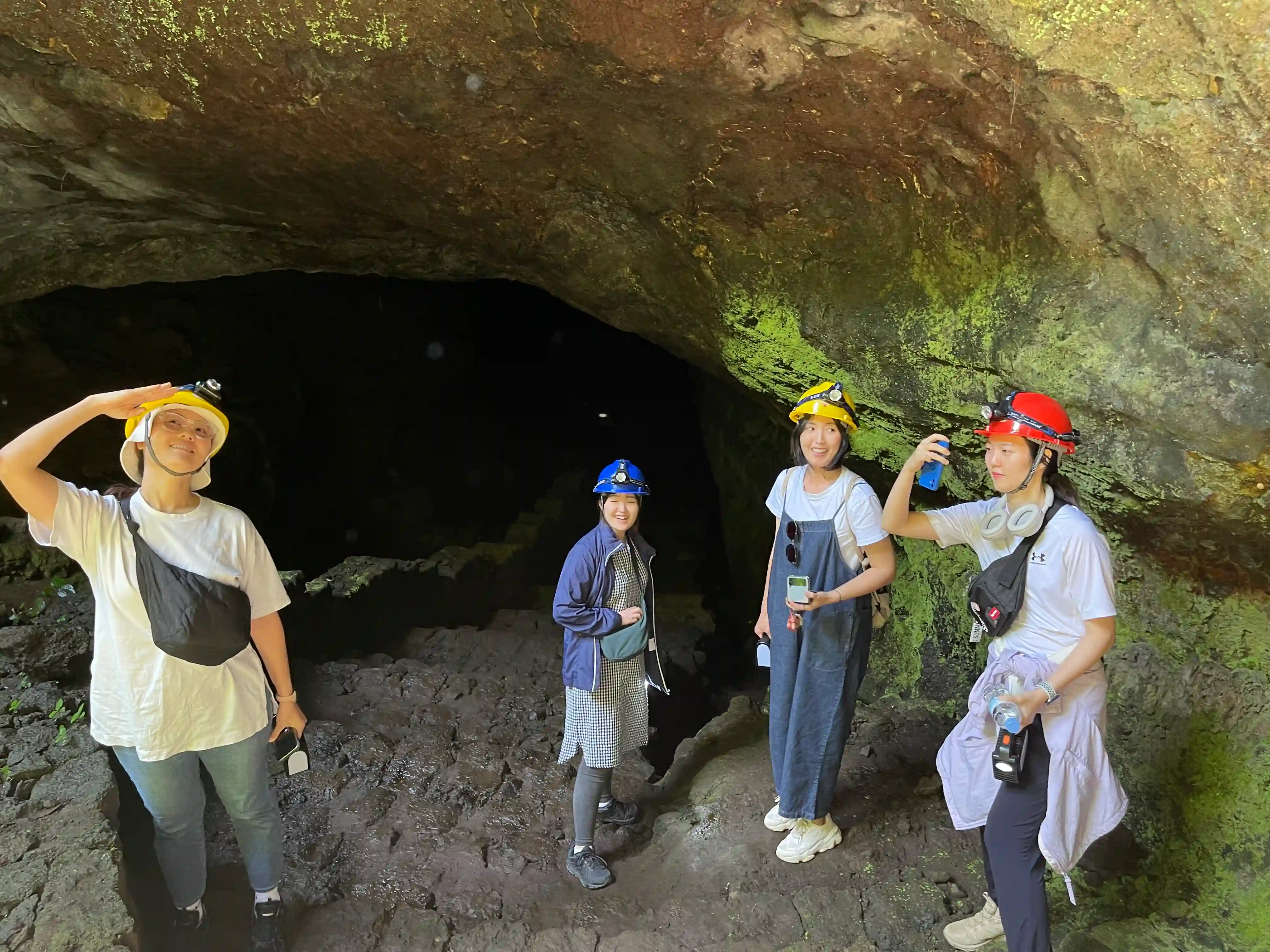 Group of women exploring Musanze Caves in Rwanda, enjoying adventure and cultural discovery