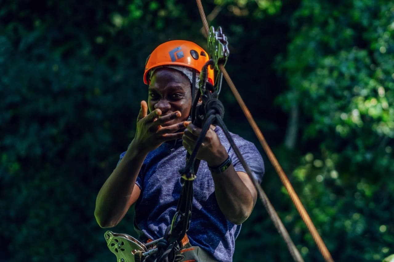 Traveler enjoying an exhilarating zipline adventure in Nyungwe National Park: Complete Travel Guide